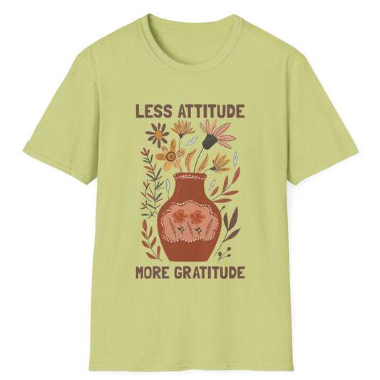 Light green t-shirt with floral design and text 'LESS ATTITUDE MORE GRATITUDE' on a white background